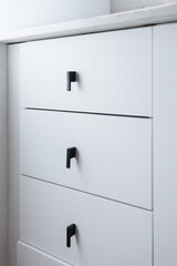 White drawers in modern kitchen with contemporary black handles - stock photo - light, white quartz...
