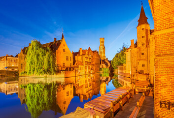 Bruges, Belgium. Twilight Rozenhoedkaai in golden hues water canal reflection
