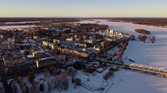 Tornio City in Frozen River Torne Delta in Wintertime, Aerial Pullback