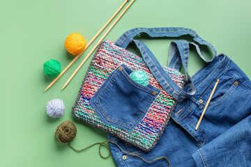 Old jeans and denim and knitted bag with sewing accessories. Top view. Recycling concept. Crafting...