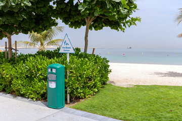 Dog-friendly beach in Dubai Islands with clean green lawn, pet waste station, and modern infrastructure. Peaceful place for pets and owners to relax by the sea