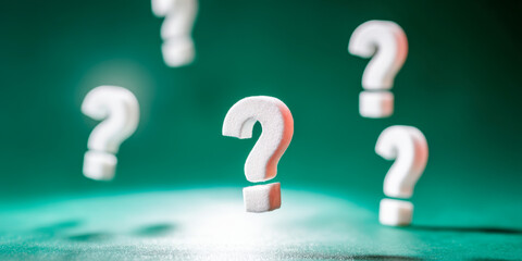 Studying question marks in creative design with a vibrant green background