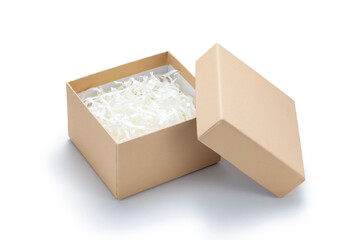 Brown gift box with shredded paper on white background