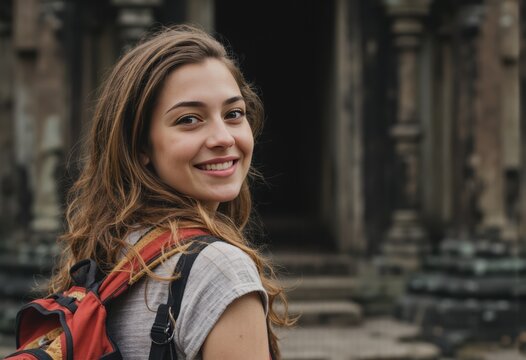 Smiling woman with a backpack exploring ancient temple ruins - Powered by Adobe