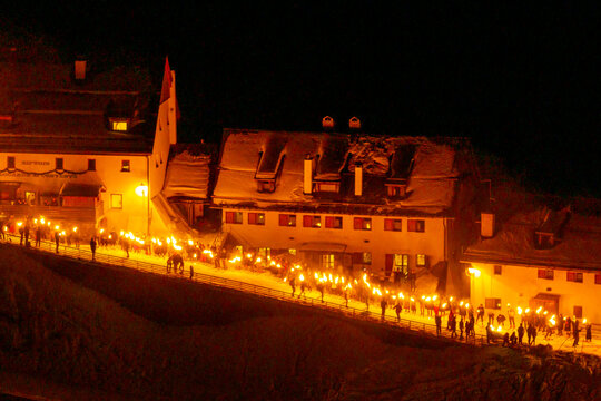 Night aereal view of Monte Santo di Lussari, Italy. The Di Prampero slope in Camporosso welcomed the new year with the longest torchlight procession in the entire Alpine arc.