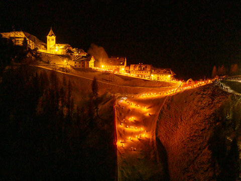 Night aereal view of Monte Santo di Lussari, Italy. The Di Prampero slope in Camporosso welcomed the new year with the longest torchlight procession in the entire Alpine arc.