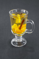 Citrus drink with cinnamon and vanilla stick