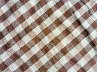 Red and white checkered fabric with a seamless gingham pattern, perfect for a picnic tablecloth texture or textile design