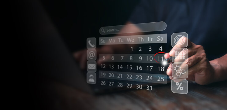 ฺฺBusinessman manages time for effective work. Calendar on the virtual screen interface, Reminder appointment. Business Planning Calendar and Project management concept.