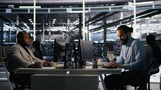 Angry data center engineer banging fist on desk after seeing system failure. Server farm IT expert reacting furiously to unstable infrastructure performance, leaving office, camera A