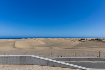 Desert landscape and sand dunes in Maspalomas. View of dunes and sea. Gran Canaria Island Spain