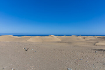 Desert landscape and sand dunes in Maspalomas. View of dunes and sea. Gran Canaria Island Spain