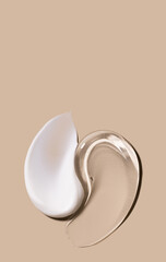 creamy texture of cosmetic samples on a pastel beige background