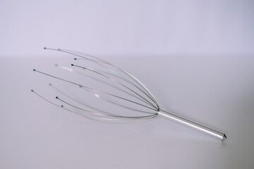 Head massager tool for relaxation and stress relief on a plain background