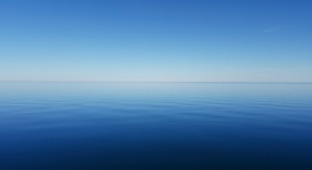 Obraz premium Serene expanse of calm, blue water meeting a clear, azure sky; a tranquil horizon