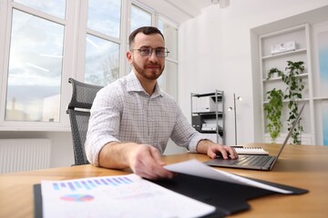 Handsome man working at desk in office