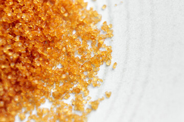 Organic cane sugar crystals on a plate. Macro shot