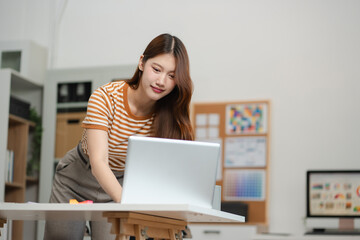 Designer woman thinking ideas strategy about mobile app interface wireframe design with customer breif and color code, User experience concept.