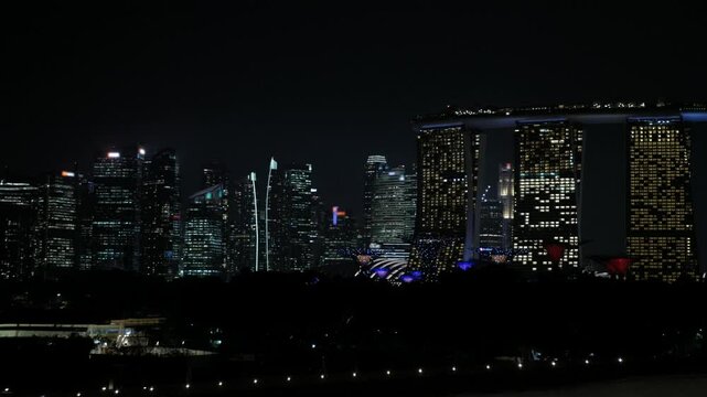 Singapore skyline city with modern office highrise skyscraper financial buildings in city central business district in night time with lighting.modern glasses financial modern buildings in 4k video