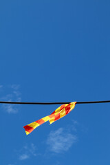 electric cable with plastic signaling ribbon outdoors against blue sky