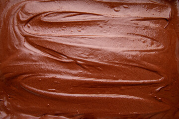 Close Up Top View of Handmade Melted Chocolate Brownie Mixture Background