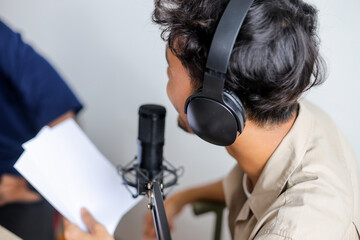 Host Man Attentively Listening to His Guest During Podcast Recording in Studio Environment