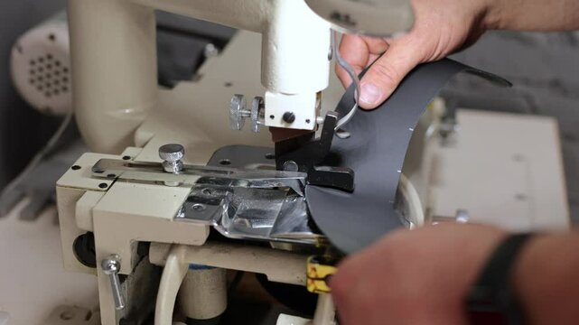 Sewing machine in the workshop for making a new leather cover for the steering wheel on a car.