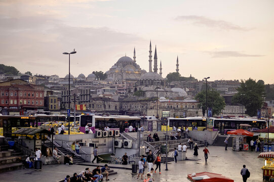 Bustling plaza at dusk with mosques and minarets in Istanbul's skyline. Istanbul, Turkey