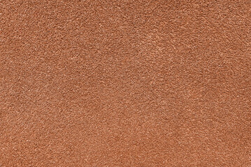 Fototapeta premium Grainy texture of asphalt, plaster, cement, plastic, rock, stone close up, macro. Background of orange colored granular wall surface, rough backdrop