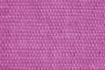 Texture of pink natural fabric with large weaving. Surface, structure of upholstery or carpet material, cloth background close up.