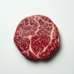 Fototapeta premium Juicy marbled beef steak with intricate fat patterns displayed on a plain white surface in a well-lit setting