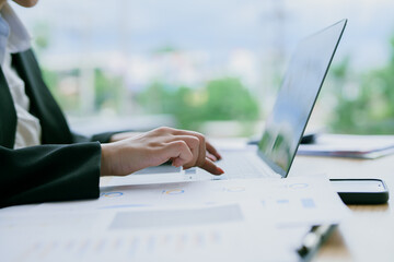 Fototapeta premium .Attractive pretty Asian businesswoman sitting working in front of laptop and thinking of new ideas in office.