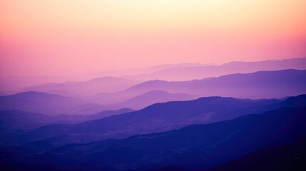 Misty mountain ranges at sunrise in soft pastel hues.