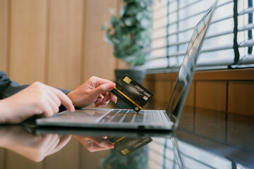 Asian woman paying with credit card online
