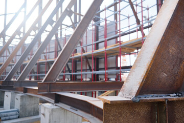 Welded i-beams and scaffoldings at construction site. Stand for metal structures assembling. Metal supporting structures
