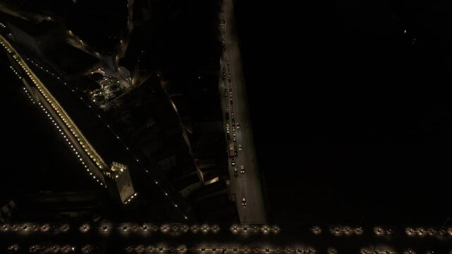 Drone flies at night to the right from Muralha Fernandina across Luis I bridge to the Miradouro da Serra do Pilar in Porto, Portugal