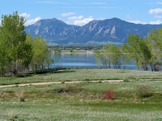 Spring lakeside trail with a view of Flatirons, Rocky Mountains, Colorado
