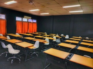 Empty contemporary conference room with chairs and tables for business meeting or classroom training