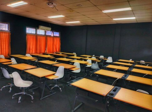 Empty contemporary conference room with chairs and tables for business meeting or classroom training
