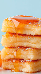 Fluffy pancakes are stacked high, glistening with sweet syrup that drips down the sides, creating a mouthwatering breakfast delight in a cozy kitchen environment