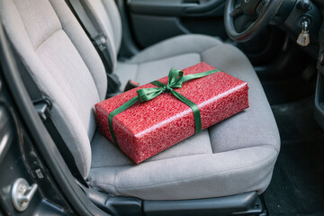 red gift box sitting in the back seat of a car