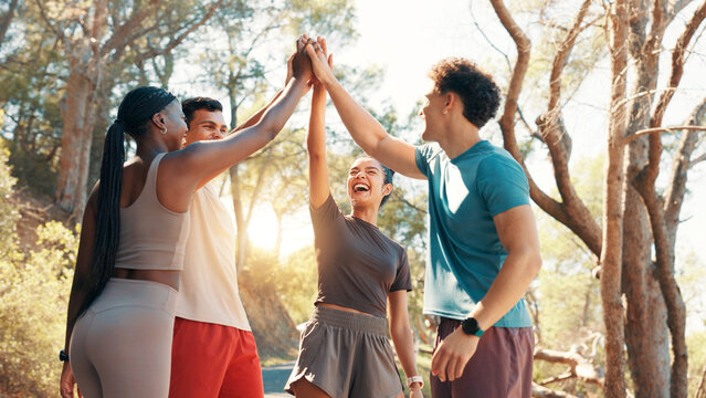 Happy people, fitness and high five in huddle for workout goals, winning or teamwork in nature. Active, group or friends with smile or motivation for success, exercise or health and wellness together