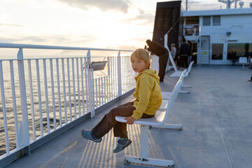 People, enjoying ferry ride between Bodo and Lofoten Moskenesoya summertime, child and adults on a ferry