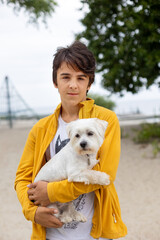 Happy children on the beach, swinging in a big round swing