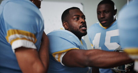 Black man, group and players huddle for football motivation, sports meeting and game plan in locker...