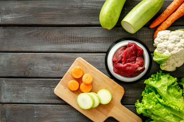 Cooking natural pet food with meat and vegetables, top view