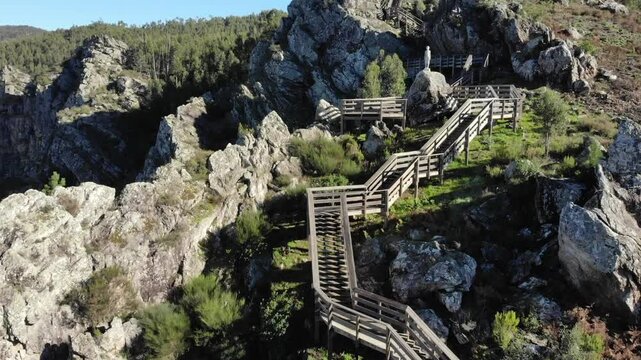Crags at S&atilde;o Sim&atilde;o Portugal. Short video clip rising up along a wooden pathway with a sculpture by Joana Alves in the public domain, depicting a simple child contemplating the landscape.