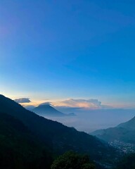 Sunrise Over Misty Mountains and Valley Town