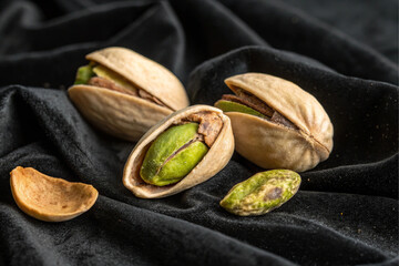pistachio nuts on black background