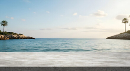 Empty light gray concrete surface overlooking a blurred ocean scene with palm trees and rocks. Peaceful coastal vista with a flat, uncluttered surface for product placement.